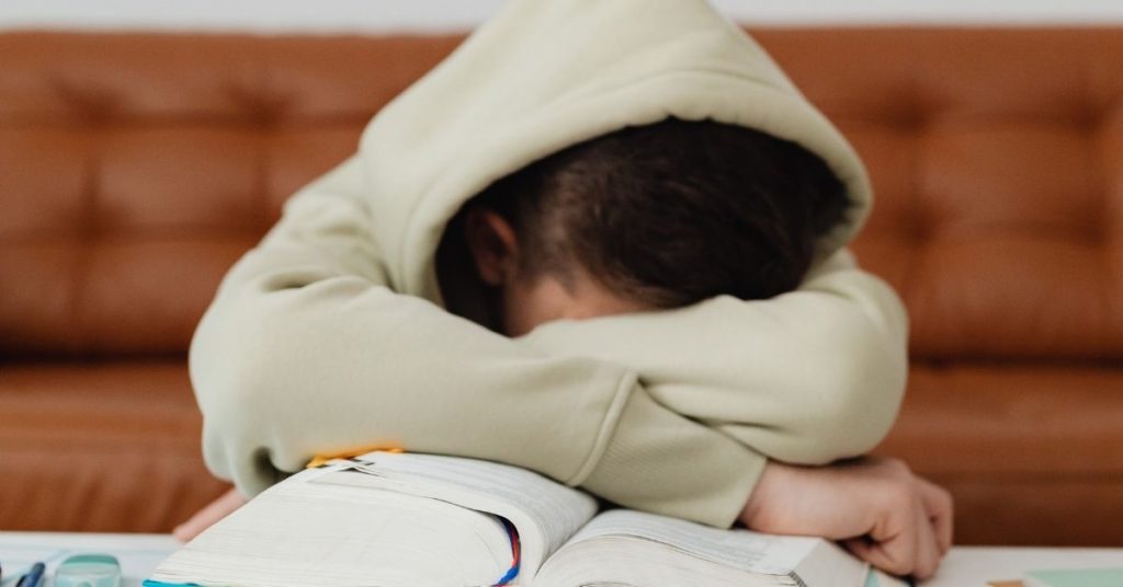 9 Reasons Educational Crafts are Worth Your Time exhausted child with his head down