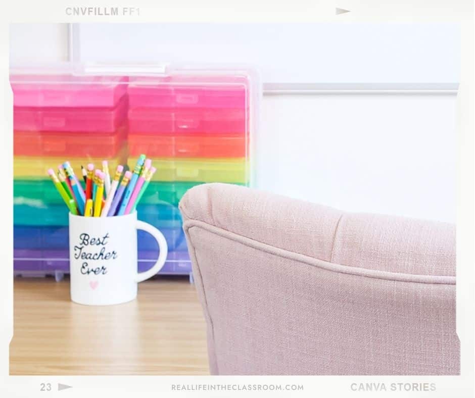 A teacher's desk with a mug filled with pens and some neat storage bins stacked