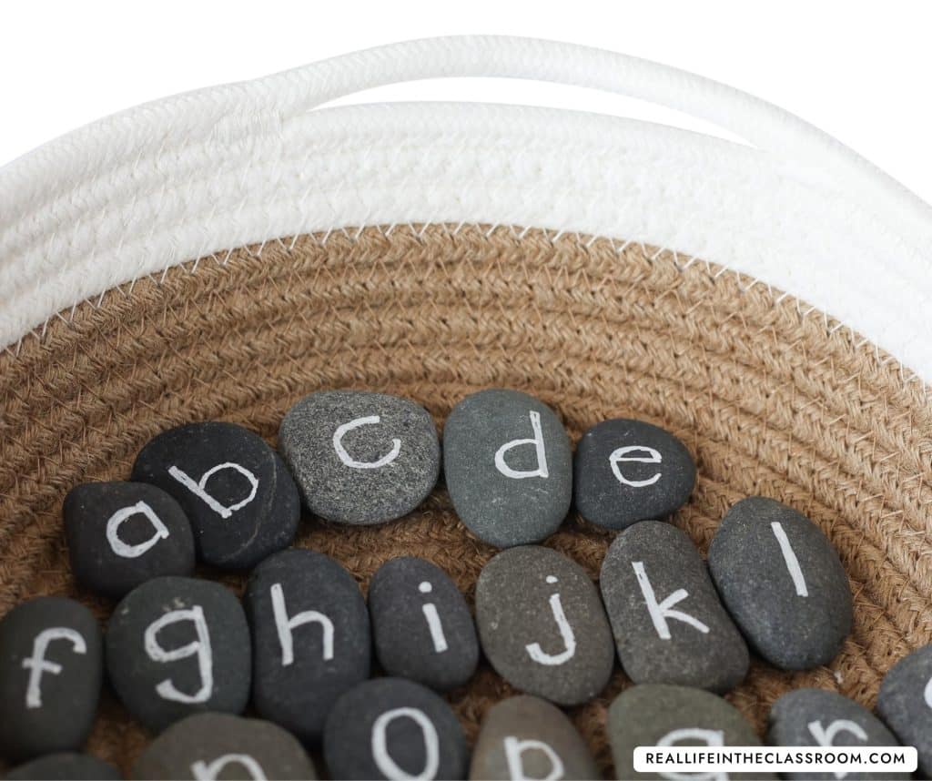 a basket of gray stones with letters printed on each one