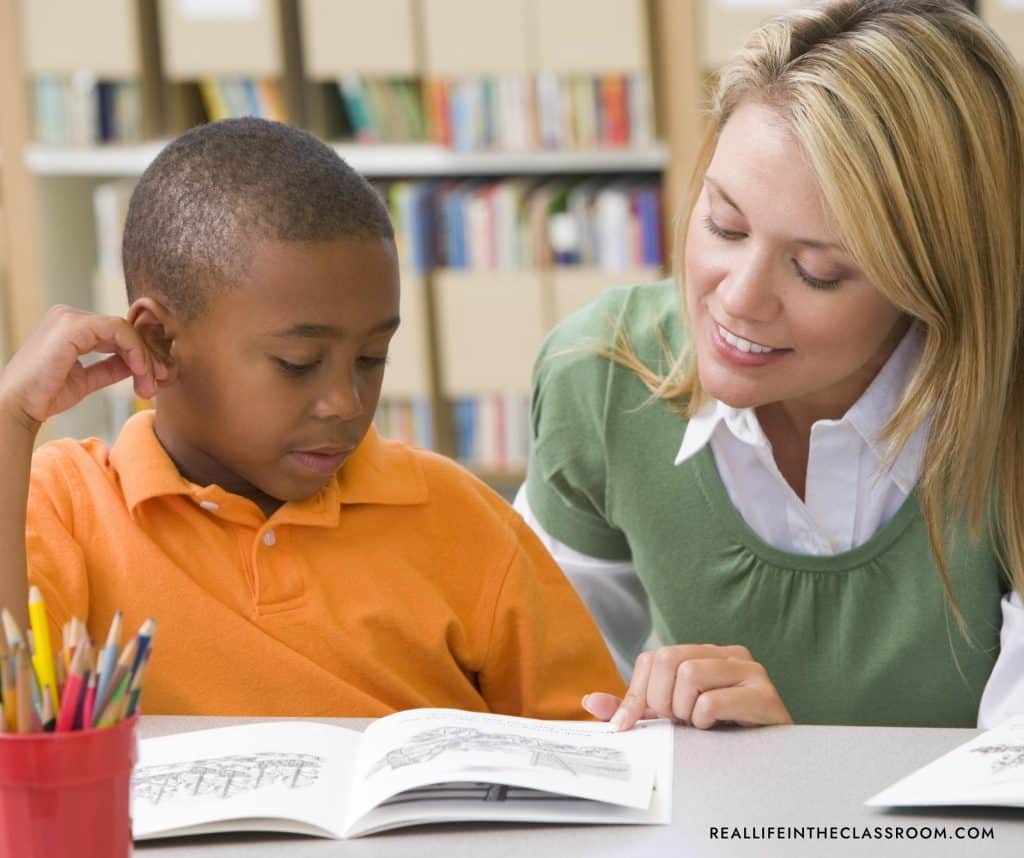 a female teacher reading with a student